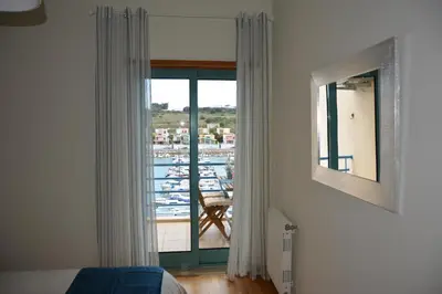 a bedroom with a window with a view of a harbor at Stunning Apartment with Marina Views in Albufeira