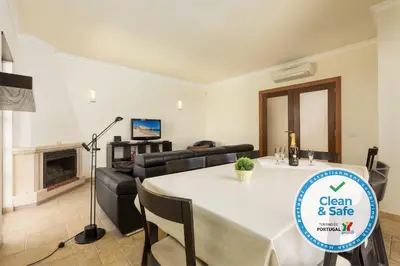 a living room with a table and a couch at Moradia Ricardo - Praia da Gale in Albufeira