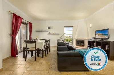 a living room with a couch and a table at Moradia Ricardo - Praia da Gale in Albufeira