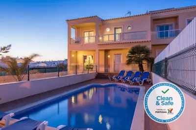 a house with a swimming pool in front of it at Moradia Ricardo - Praia da Gale in Albufeira