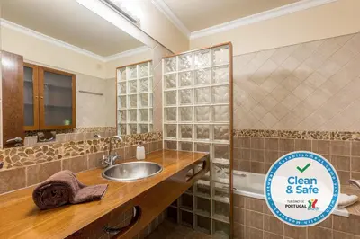 a bathroom with a sink and a sign for clean and sale at Moradia Ricardo - Praia da Gale in Albufeira