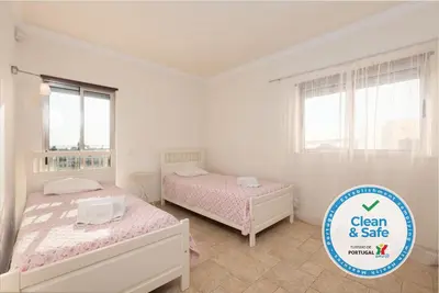 a bedroom with two beds and a sign that says clean and sale at Moradia Ricardo - Praia da Gale in Albufeira