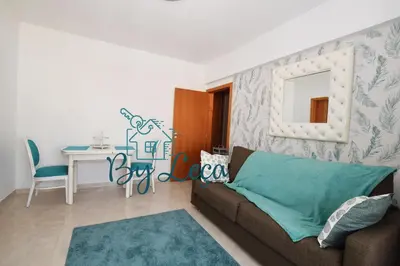 a living room with a couch and a table at Irene's Place in Quarteira