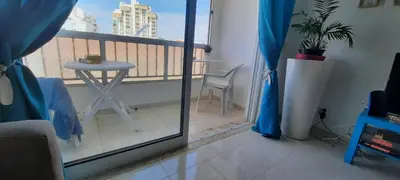 a room with a balcony with a table and a chair at Irene's Place in Quarteira