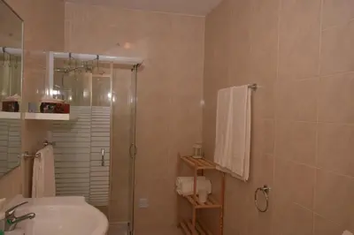 a bathroom with a shower and a sink at Irene's Place in Quarteira