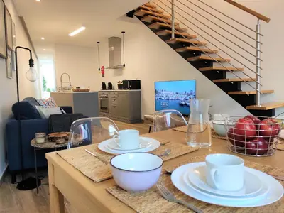a kitchen with a table with plates and bowls on it at Casa da Mouraria in Faro