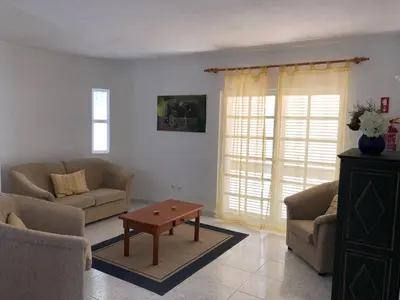 a white kitchen with white cabinets and a window at Nightingale Villa in Albufeira