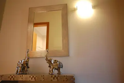 a bathroom with a mirror and two statues of giraffes at São Rafael Beach 300 m - Vila Rosal house in Albufeira
