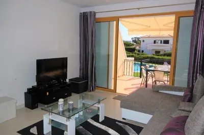 a living room with a couch and a tv and a table at São Rafael Beach 300 m - Vila Rosal house in Albufeira