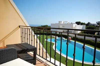 a balcony with a view of a swimming pool at São Rafael Beach 300 m - Vila Rosal house in Albufeira