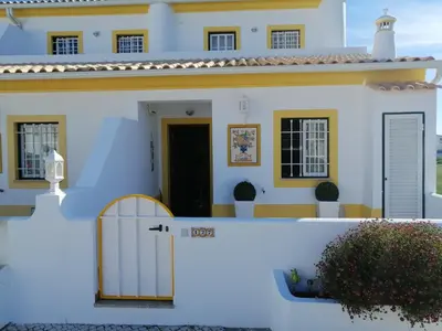 a hallway of a white building with a red tile floor at Beautiful Vila Rafaella, walk distance to beaches in Albufeira