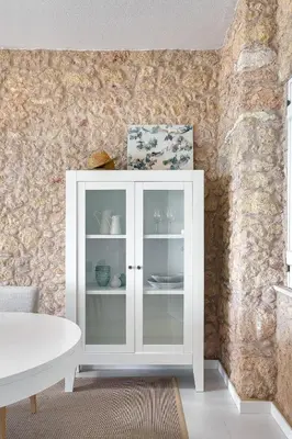 a white cabinet with glass doors in a room at Casa Pé na Areia- Unique Spot- Beach front by DreamvillasAlbufeira in Albufeira