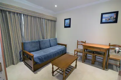 a living room with a couch and a table at Beach Waves - Albufeira in Albufeira