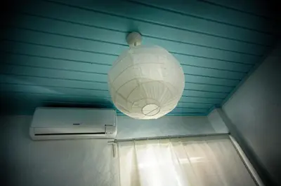 a light hanging from a ceiling with a paper lantern at Traditional House in Historical Center of Faro in Faro