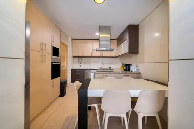 a kitchen with a table and chairs in a room at Stunning Villa with Pool in Albufeira