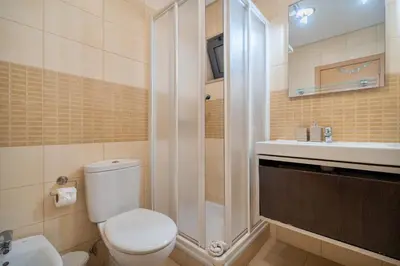 a bathroom with a toilet and a shower and a sink at Stunning Villa with Pool in Albufeira