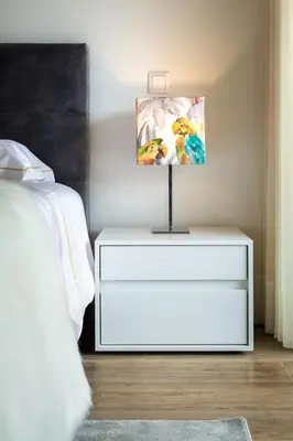 a white dresser with a painting on it next to a bed at Victory Village 3B in Quinta do Lago