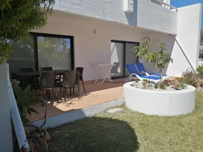 a house with a patio with chairs and a table at Victory Village 3B in Quinta do Lago