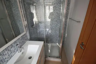 a bathroom with a sink and a glass shower at Comfortable studio in Albufeira - 20 m² - Pleasant balcony in Albufeira