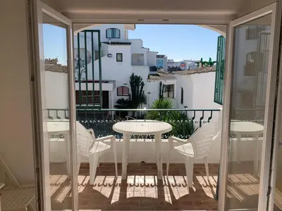 a view of a balcony with a table and chairs at A CASINHA - Pateo Aldeia in Albufeira