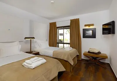 a hotel room with two beds and a window at Sao Rafael Holidays in Albufeira