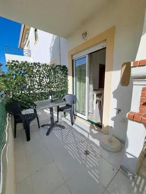 a patio with a pizza oven on the side of a house at Apartamentos Roja Sol in Albufeira