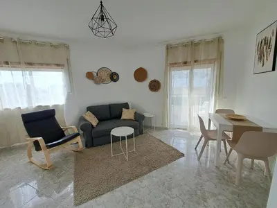 a bedroom with a large bed and a dresser at Apartamentos Roja Sol in Albufeira