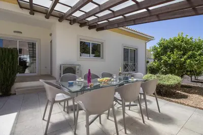 a dining table and chairs on a patio at Villa Maresia in Galé