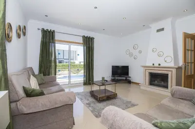 a living room with two couches and a fireplace at Villa Maresia in Galé