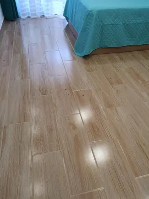 a wooden floor in a room with a bed at Lux Home in Albufeira