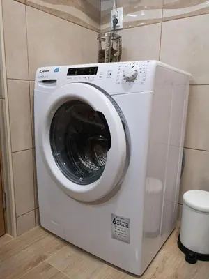 a washing machine in a bathroom with a toilet at Lux Home in Albufeira