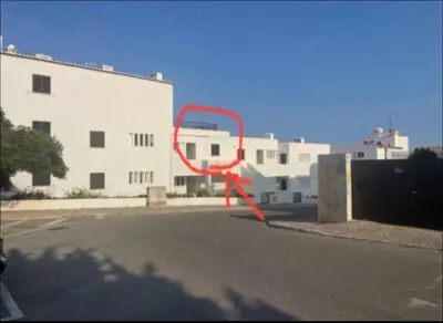 a red object in a parking lot next to a building at Vista Mar e Terra in Albufeira