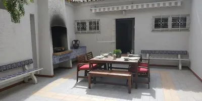 a wooden table and chairs on a patio at Casa Albacor in Vilamoura