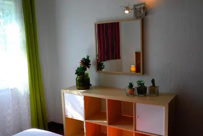 a dressing table with a mirror and potted plants on it at Casa Albacor in Vilamoura
