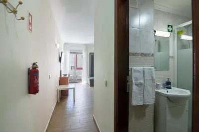a bathroom with a sink and a fire hydrant at Albufeira Beach Studio in Albufeira