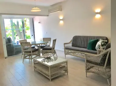 a living room with a couch and chairs and a table at B2 Marina Vilamoura Apartment in Quarteira