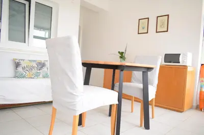 a dining room with a table and two chairs at Estúdio-Gambelas in Faro