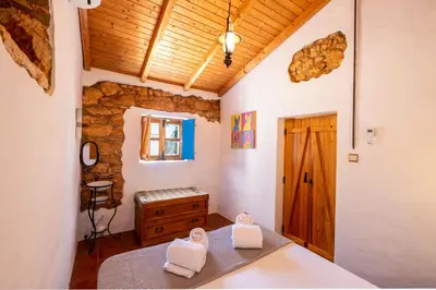 a bedroom with two towels on a bed with a wooden ceiling at Villa Monte Algarvio - Private Heated Pool - wifi in Tunes