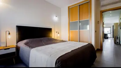 a bedroom with a large bed in a room at Parque Atlântico com Vista Mar in Quarteira