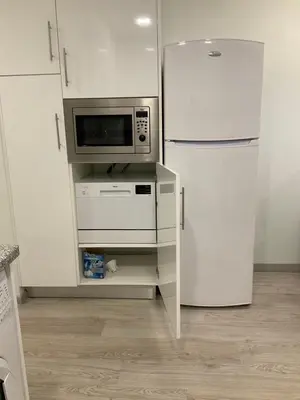 a kitchen with a refrigerator and a microwave at magnifico apartamento in Albufeira