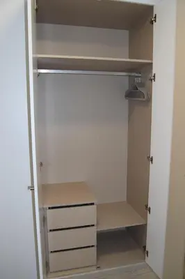 a closet with white cabinets and a shelf at magnifico apartamento in Albufeira