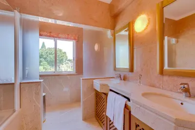 a bathroom with a large sink and a window at OnJ Vilamoura in Quarteira