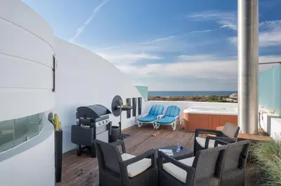 a patio with chairs and a grill on a roof at Romy in Vale do Lobo