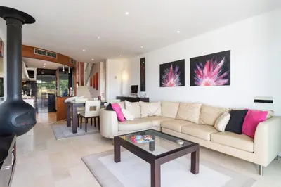 a living room with a couch and a table at Romy in Vale do Lobo