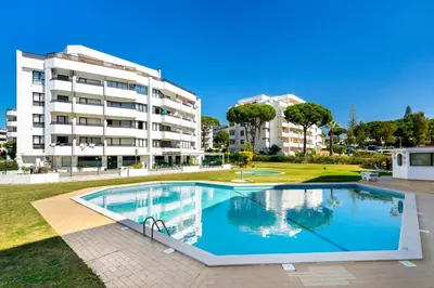 a large swimming pool in front of a building at WHome | Vilamoura Sunny Apartment in Quarteira
