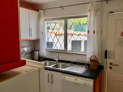 a kitchen with a sink and a window at Casa Nicho in Vale do Lobo