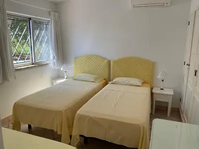 a bedroom with two beds and a window at Casa Nicho in Vale do Lobo