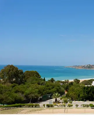 a view of a beach with the ocean in the background at Quinta Barracuda Albufeira in Albufeira