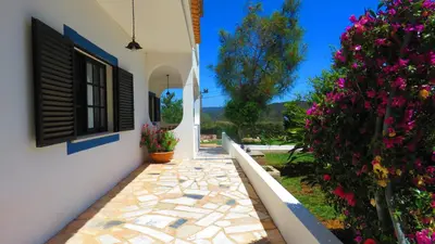 a walkway leading to a house with flowers at Monte Madalena in Adega