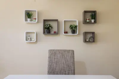 a white wall with three mirrors and potted plants at FLH Falésia Flat with Pool in Vilamoura